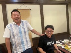 挨拶中の新入青年部会員　有限会社　安藤測量　安藤　様（写真左）